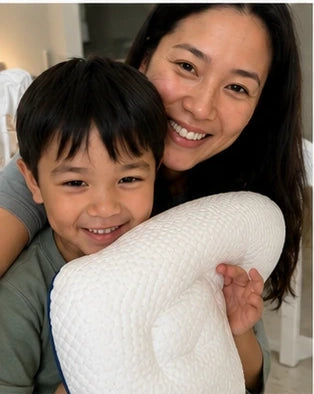 Parent and Child holdiing a Ukola pillow